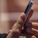 max-amp-rv-cellphone-booster-kit Man Holding Cell Phone